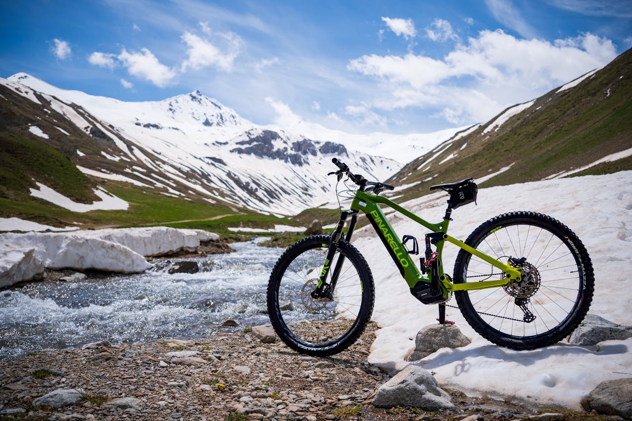 A Bicycle Standing on the Snowy Ground in the Mountains